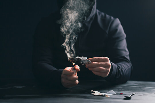 Drug addict man or drug dealer prepares heroin.
