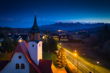 The church in Czarna Gora and the road to the Tatra Mountains at dusk. Poland