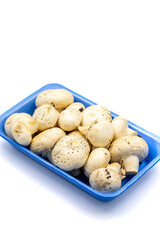 Packaged mushrooms isolated on a white background. Cultivated mushroom or portabello mushroom