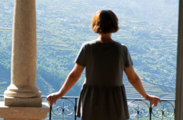 Fototapeta premium woman from balcony looking the Vale do Douro valley in Portugal , Europe , world heritage site , focus in background