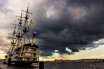 Fototapeta na wymiar Russia, the center of St. Petersburg, the Neva Embankment. Flying Dutchman, an ancient ship restaurant on the river. The symbol of the city