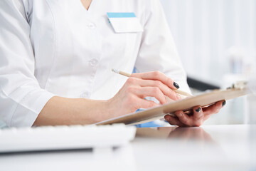 Caucasian female doctor working in her office