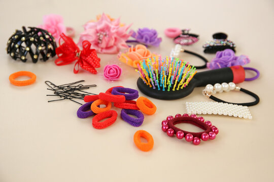 Different hair clips on beige background.