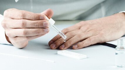 doctor applies reagent to covid 19 buffer. Omicron variant