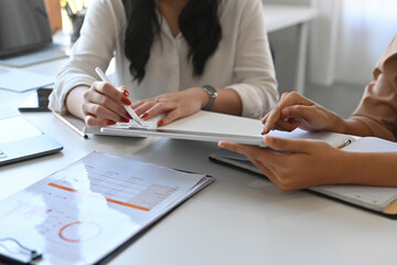 Cropped view workers working on a document in the office together , For business and office work.