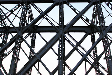 High voltage transmission tower line against blue sky, bottom view. iron construction.
