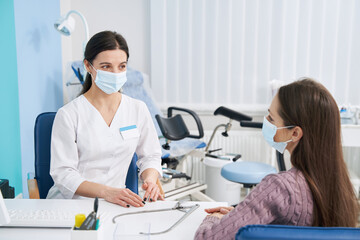 Professional gynecologist receiving female patient in her office