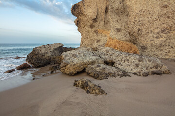 Cliffs and rocks at the coast of Andalusia, Spain; conglomerate rocks on the beach of Playa de Mónsul eroded by water of the sea
