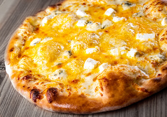 Quattro Formaggio (Four Cheese) Pizza. Italian pizza on wooden table background