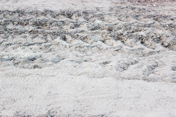 Close up and top view of shiny clear yellow sand on the beach with water wave and white bubble shows the beauty of a natural vacation spot in summer 