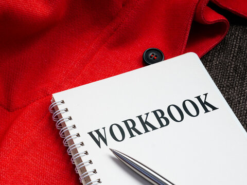 A Workbook with pen on the sofa.