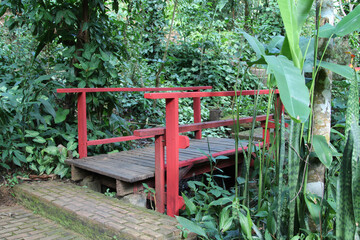 The old wooden bridge crosses to the garden.