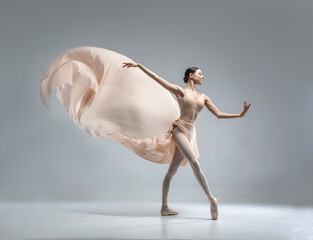 Beautiful ballerina dancing in the body color ballet leotard with body color cloth. She danced on...