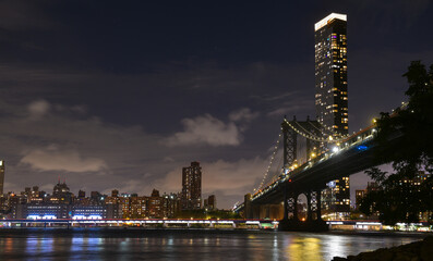Manhattan Bridge under the full moon night landscape. This amazing constructions is one of the most...