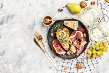 Appetizer with pear baked with blue cheese, nuts and honey, prosciutto. Summer snacks. Pear appetizer with jamon, Restaurant menu, dieting, cookbook recipe top view