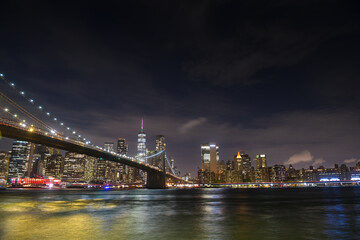 Brooklyn Bridge under the full moon night landscape. This amazing constructions is one of the most...