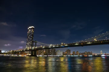 Rolgordijnen Manhattan Bridge under the full moon night landscape. This amazing constructions is one of the most known landmarks in New York. © Dragoș Asaftei
