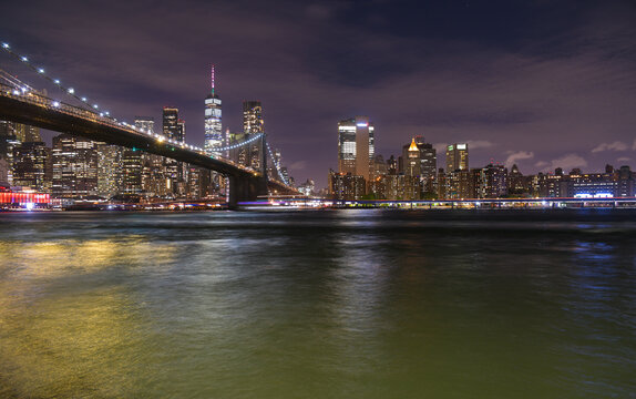 Fototapeta Brooklyn Bridge under the full moon night landscape. This amazing constructions is one of the most known landmarks in New York.