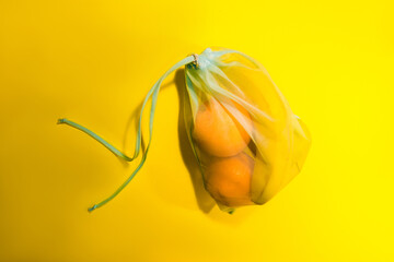  Fruits in a disposable bag on a yellow background. High quality photo