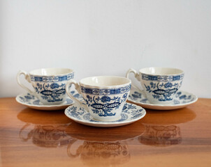 Vintage coffee cup set - china blue cups on wooden table isolated