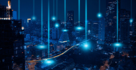 Smart city and wireless networking concept. Dot point connection technology with aerial view city background at night. - obrazy, fototapety, plakaty