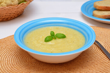 cauliflower soup puree decorated with basil