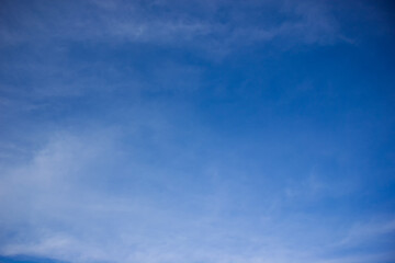 Blurred sky background. White mist across the blue sky.