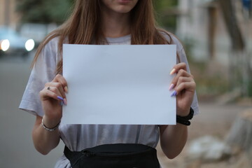 a man with a blank sheet of paper in his hands