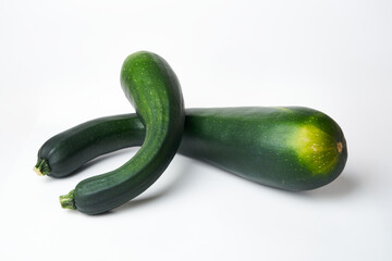 two green zucchini on a white background close-up
