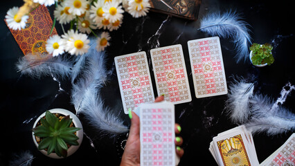 Woman makes a forecast with Tarot cards, Fortune telling esoteric tarot predictions