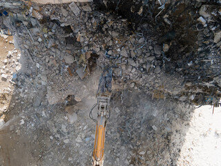 Excavator with Hydraulic Shears in action, building demolition