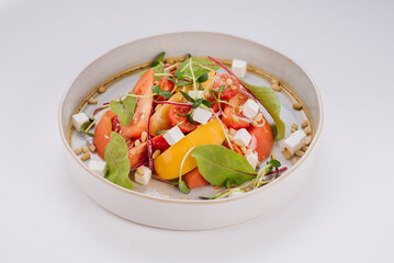 Dish of red and yellow tomatoes, cherry tomatoes, herbs, and Philadelphia cheese