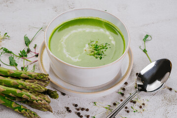 Dish of spinach cream soup and greens. Close up