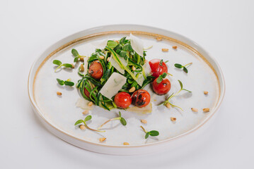 Salad of zucchini sliced ​​into strips, cherry tomatoes, parmesan cheese and microgreen. Vegan menu