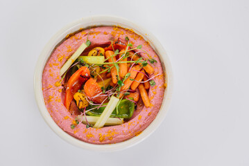 Dietary dish with boiled carrots, bell peppers and pink puree