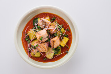 Red fish dish with zucchini and tomato sauce