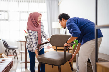 muslim young couple moving new chair at their new home