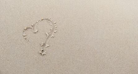 Heart drawn in the sand, symbol of love, Beach background, Valentine concept.