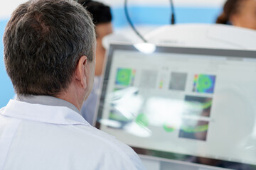 Optometrist using modern equipment to diagnose and identify major visual problems of female patient