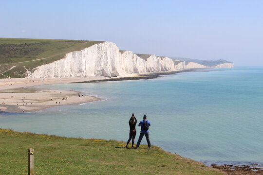 Tourists taking pictures at Seven Sister Cliff Walk (England)
