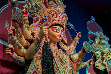 Goddess Durga idol , Durga Puja festival at night. Shot under colored light at Howrah, West Bengal,...