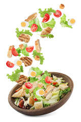 Tasty ingredients for Caesar salad falling into plate on white background