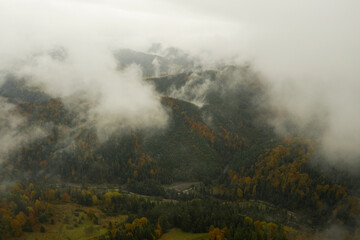 Fototapeta na wymiar Aerial view of mountains covered with fog
