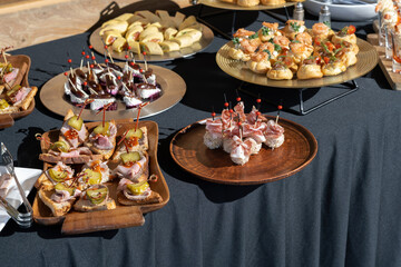 A treat for a buffet or a house party. Canape with cheese balls. The table is reserved for catering.