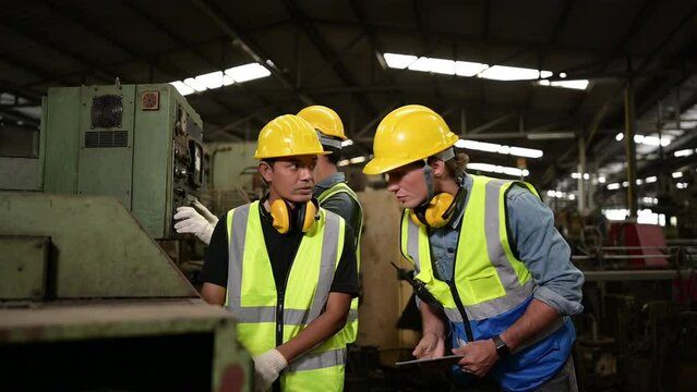 The foreign chief engineers teach and advise Asian technicians. About repairing old machinery to return to normal use