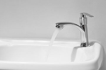 Water tap , faucet. Flow water in bathroom with sink. Modern clean hause. Backround hygiene. Panorama