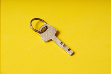 The key to the lock on a yellow background.