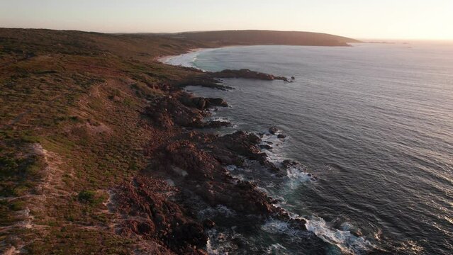 Aerial forward view of wonderful coastline at sunset. Australia. Slow motion
