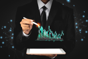 Business man holding tablet and showing holographic graphs and stock market statistics gain profits.