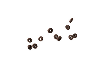 Chocolate rings cereal spill out into a bowl. Breakfast.